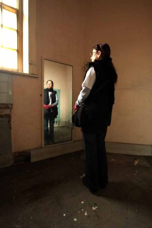 Reflective Barbara Standing by a Long Mirror